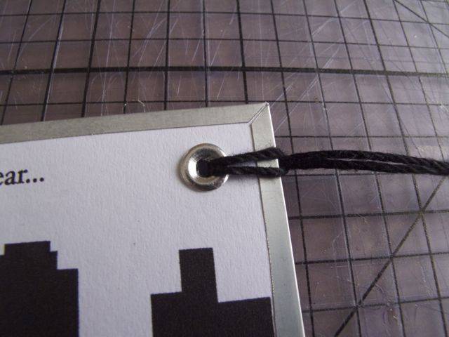 Bookmark tied with black tread.