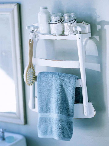 A blue bathroom area has a blue towel and accessories on a shelf.