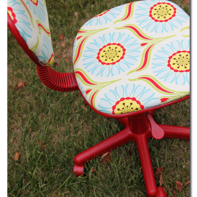 Red and blue color designer rotating chair in the garden.