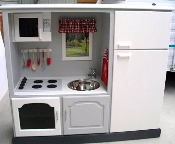 A kitchen area containing a refrigerator, stove, sink and a microwave.