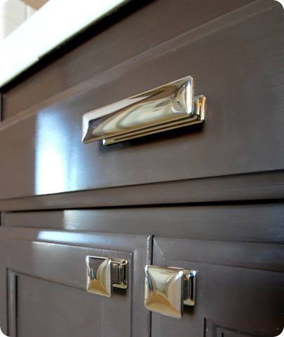 The chrome handles on a vanity cabinet.