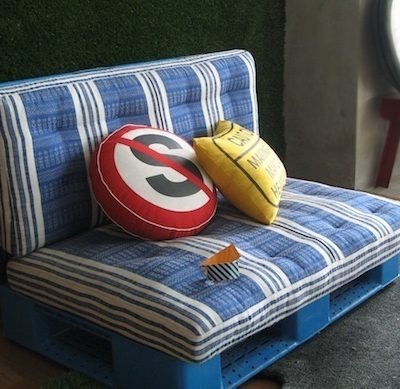 Colourful pillows are on the blue sofa.