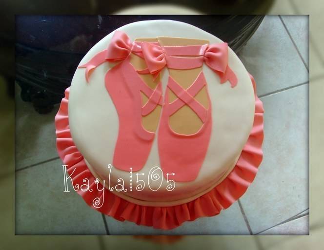 White cake decorated with pink color food ribbon .