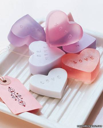 Multicolored heart shaped transparent cubes with love text in a tray.