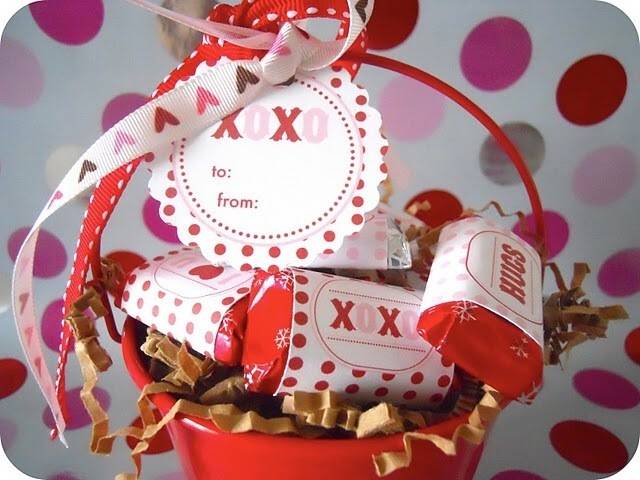 A Valentine's Day basket with homemade labeling on treats.