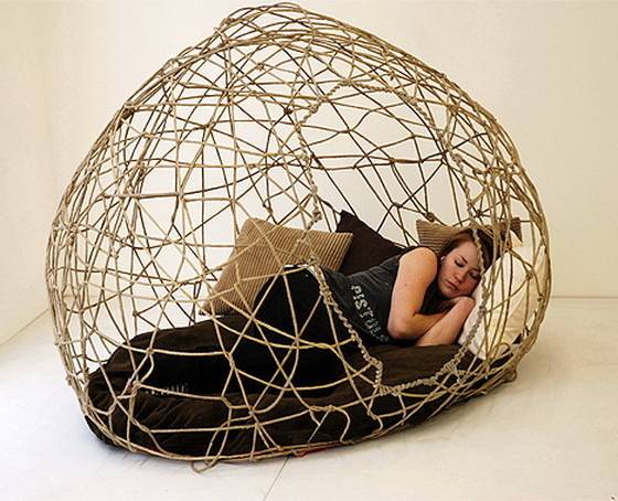 Woman sleeping on the wired cocoon bed.
