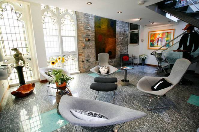Living room with gray color stylish chairs indoor plants and flowers.