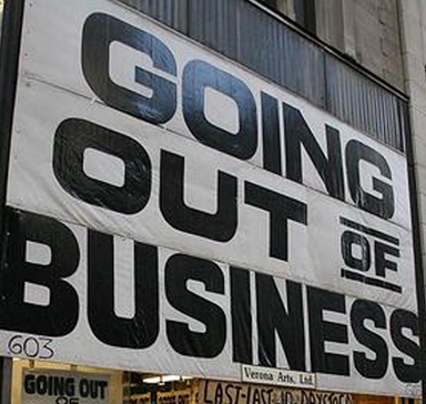A white and black going out of business sign.