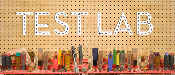 Several tools lined up on a work bench.