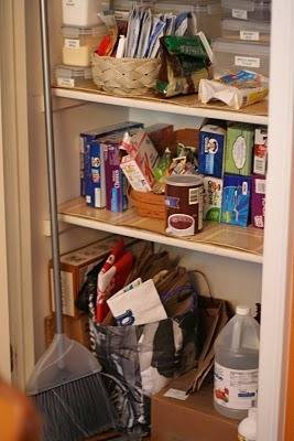 A 3 tier closet storage space with many items on each shelf.