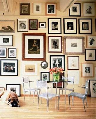 Photo gallery on walls in dining room.