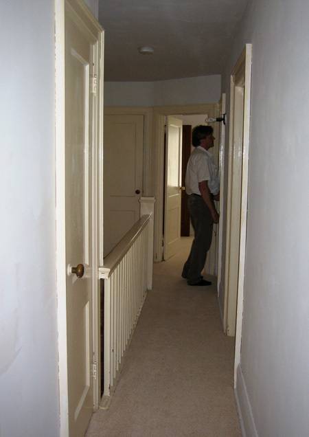 Man standing in hallway inside the house.