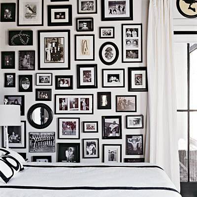 gallery wall of black and white framed photographs