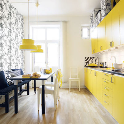 A chic modern kitchen with a yellow flair to it.
