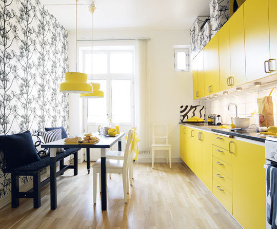 A chic modern kitchen with a yellow flair to it.