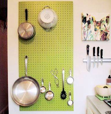 Some kitchen utensils are hanging in the kitchen walll.
