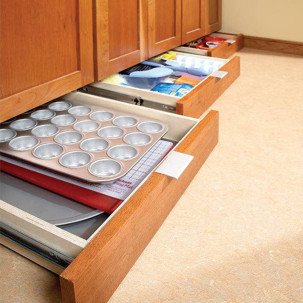 Kitchen cabinets with egg tray and kitchen storage utensils inside.