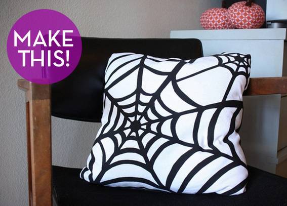Spider web printed pillow in black chair.