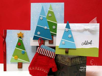 Various greeting cards for the season have blue backgrounds with white grounds and Christmas trees decorated with buttons and snowflakes