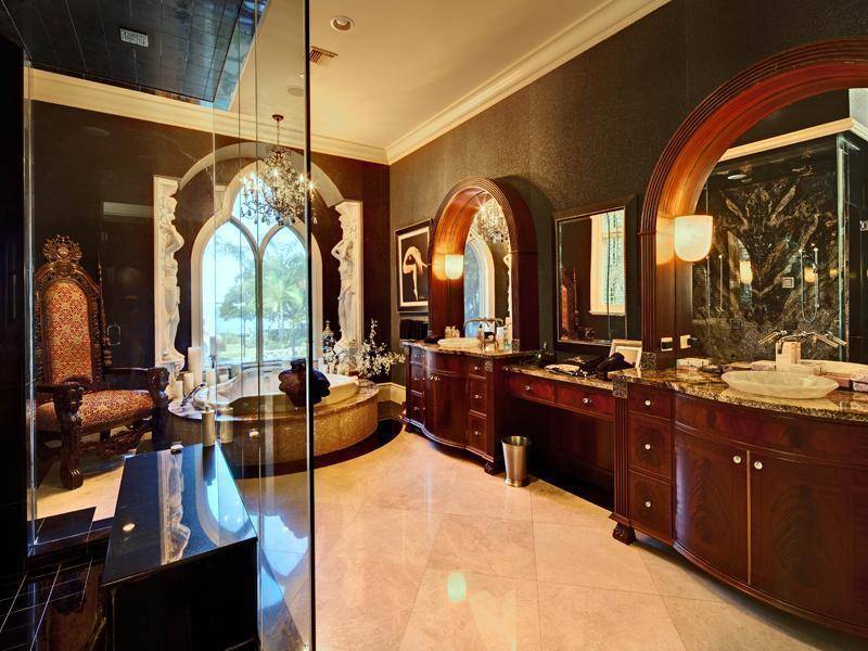 A large bathroom has two sinks and a round tub.