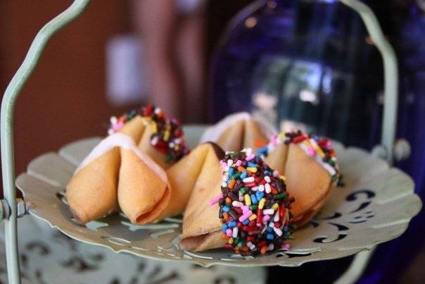 Fortune cookies sit on a white platter.