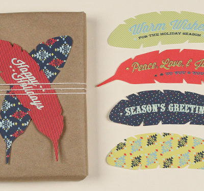 Feather shaped holiday gift tags in different colors and designs.