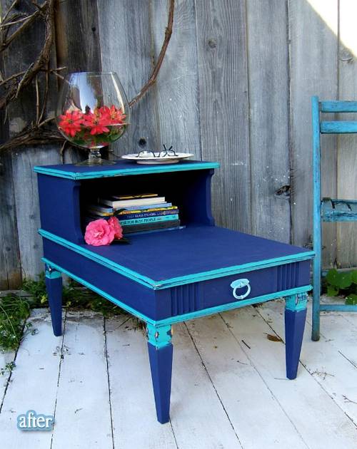 A blue table has things on it as it sits outside.