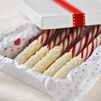 An open box of white chocolate covered candy canes.