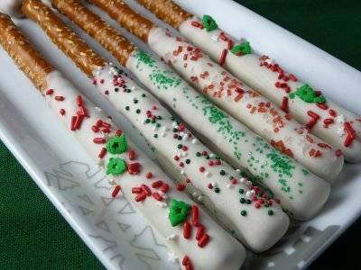 Pretzels have been rolled around in white chocolate and sprinkles.