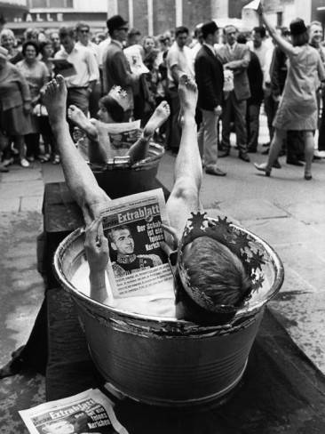 Protesters Sit in Bath Tubs and Read the Satirical Newspaper 