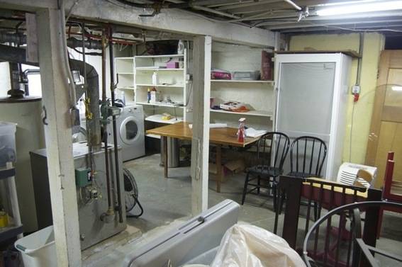 The basement of a home which pairs as a laundry room as well.