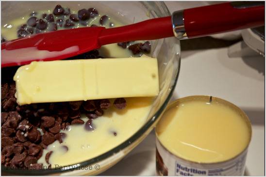 Butter, chocolate chips, and other ingredients are in a mixing bowl with a Farberware spatula.