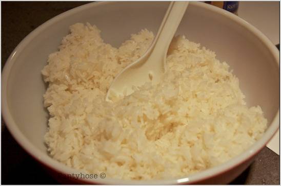 A bowl of rice with a spoon.