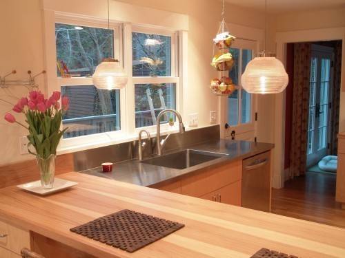 "A Beautiful Kitchen top with wooden Island Table"