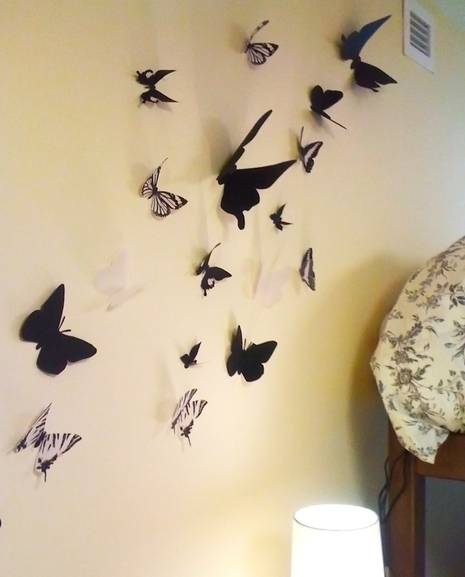 Many butterflies are on the wall.
