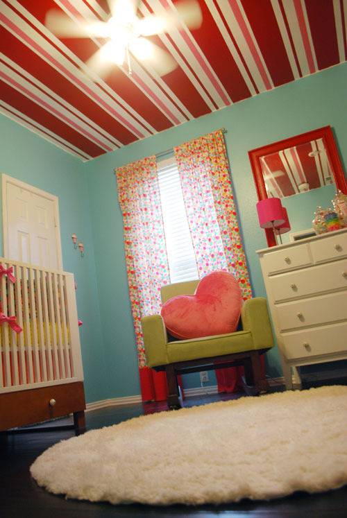 candyland themed nursery has peppermint stripe ceiling