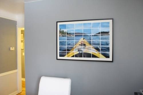 Boat is moving along the sea picture is hanging on the living room.