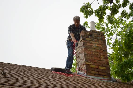 My dad helping out with chimney demolition