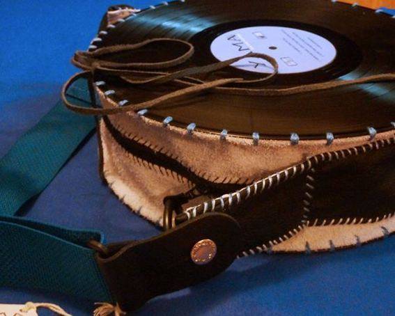 A leather purse with a record on top.