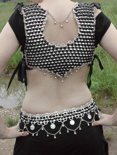Woman with designer blouse showing her back made with soda pop tabs.