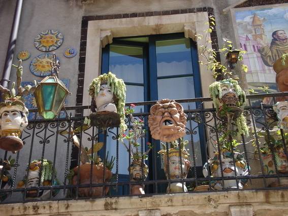 A balcony with plants and decorative pots.