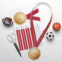 Scissors with red medal ribbons for sports.