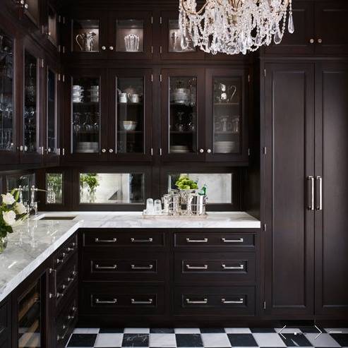 kitchens - butler's pantry espresso stained glass-front kitchen cabinets marble countertops mirrored backsplash small sink bridge faucet black white checkered floors