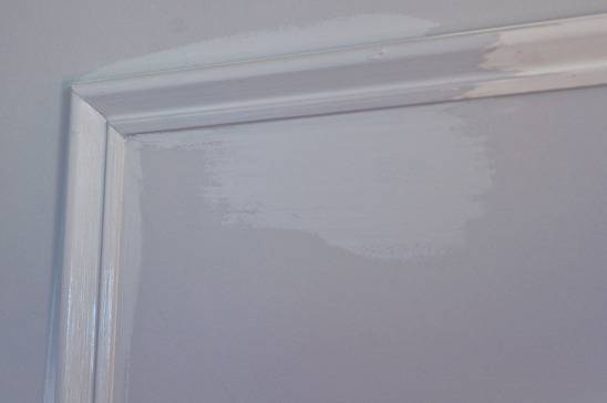 A white frame on a white wall.