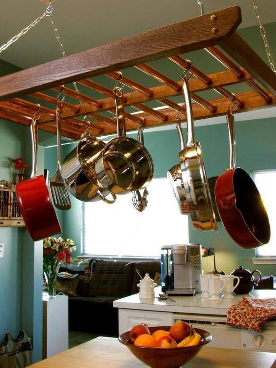 Kitchen pots hanging on a ladder above.