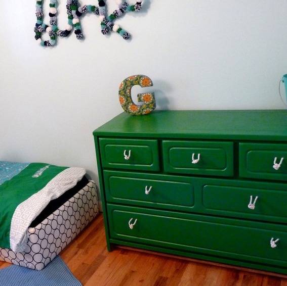 Green cabinet with G statue on top inside the room.