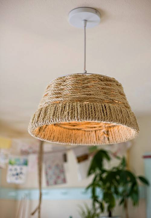 A light with a wicker shade hanging from a ceiling.