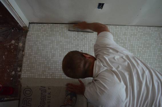 Our contractor, Bill Herschbach, setting the floor tile
