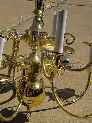 A golden chandelier with electric candles in it.