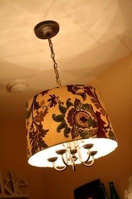 Chandelier featuring a paisley lampshade, hanging by chain from a ceiling.